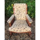 A VICTORIAN OAK OPEN ARMCHAIR The button back upholstery with vine leaf decoration on a cream