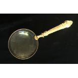 A GILT METAL DESK MAGNIFYING GLASS. (23cm)