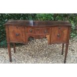 A LATE 19TH/EARLY 20TH CENTURY MAHOGANY SERPENTINE FORMED SIDEBOARD With an arrangement of cupboards