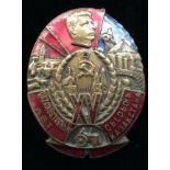 A RUSSIAN OVAL ENAMEL BADGE Displaying a complex of domestic and productive industrial life in the