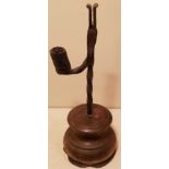 AN 18TH CENTURY IRON TABLE RUSHLIGHT AND CANDLE SOCKET With spiral twist stem and arm, raised on a