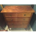 AN EDWARDIAN MAHOGANY CHEST Of four long drawers, with satinwood banding and raised on square