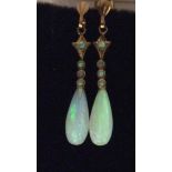 A PAIR OF EDWARDIAN 14 CARAT GOLD AND OPAL DROP EARRINGS Three small opals set in a linear setting