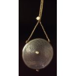 AN EDWARDIAN 15CT GOLD, ENAMEL AND SEED PEARL PENDANT/LOCKET AND CHAIN The flat circular locket