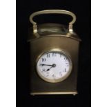 AN UNUSUAL EARLY 20TH CENTURY FRENCH GILT BRASS CARRIAGE CLOCK The domed top with carry handle and