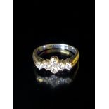 AN 18CT WHITE GOLD AND DIAMOND CLUSTER DRESS RING Four uniform brilliant cut diamonds in a lozenge