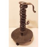 AN 18TH CENTURY SPIRAL STEEL CANDLESTICK With drip tray, standing on three scrolling legs. (22cm)