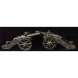 A PAIR OF 20TH CENTURY CAST IRON MODEL CANNONS The barrels bearing a shield with a crown and two