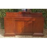 A VICTORIAN FLAME MAHOGANY SIDEBOARD The two frieze drawers above recessed cupboards, flanked by