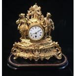 A LATE 19TH CENTURY GILDED METAL MANTLE CLOCK The spelter case with cast windmill, above a painted