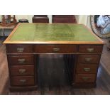 A VICTORIAN MAHOGANY PARTNERS DESK With a green tooled leather top above and arrangement of nine