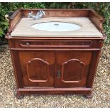 A 19TH CENTURY MAHOGANY WASHSTAND The galleried marble top above a single drawer and cupboard,