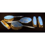 AN EARLY 20TH CENTURY ART DECO CHROME AND BLUE ENAMEL DRESSING TABLE SET Including a hand mirror,