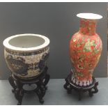 A CHINESE FISH BOWL Along with a large vase, both with floral decoration and hardwood stands.