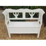 A DUTCH PAINTED PINE SETTLE The scroll ends and pierced fret panels above a rise and fall seat,
