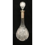 AN EARLY 20TH CENTURY CUT GLASS SLENDER NECK DECANTER AND STOPPER With hallmarked silver collar. (