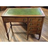 AN EDWARDIAN MAHOGANY DESK With satin banding and a green tooled leather top, above an arrangement