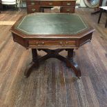 IN THE MANNER OF GILLOW, A LATE VICTORIAN MAHOGANY DRUM/WRITING TABLE The hexagonal top with green