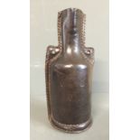 A 17TH/18TH CENTURY LEATHER BOTTLE With a leather coil insert to neck forming the bunghole and