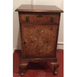 AN EARLY 20TH CENTURY WALNUT BEDSIDE CABINET With a single drawer above a cupboard, raised on