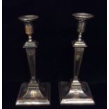 A PAIR OF EARLY 19TH CENTURY SILVER PLATE ON COPPER CANDLESTICKS Of Neoclassical design, having a