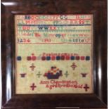 A 19TH CENTURY WOOLWORK TAPESTRY SQUARE SAMPLER With the alphabet, biblical quote and a basket of