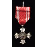 JAPAN, A SILVER AND WHITE METAL ENAMEL MEDAL FOR MERIT On a red and grey striped ribbon (no case).