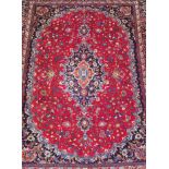 A PERSIAN MAHAL WOOLLEN CARPET The central red floral field, contained within five running