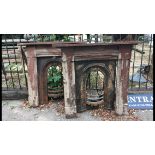 A PAIR OF EARLY VICTORIAN CAST IRON FIRE PLACES The arch section with organic cartouches and pine
