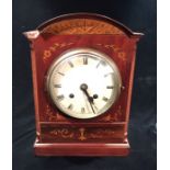 AN EDWARDIAN MAHOGANY MANTLE CLOCK The arched case with satin inlaid floral decoration and painted