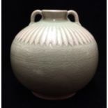 AN ORIENTAL CELADON GLAZED SPHERICAL SQUAT VASE With twin scroll handles and moulded flutes to
