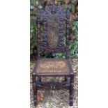 A LATE 19TH/EARLY 20TH CENTURY OAK CAROLEAN STYLE CHAIR Carved with a central crown flanked by