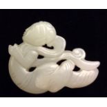 A CHINESE WHITE JADE APSARA PENDANT Carved as a deity flying amongst stylized clouds, representing