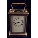 HARRODS LTD LONDON a late 19th century gilt brass carriage clock with swan neck handle, oval