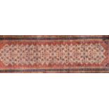 SAMARKAND, AN ANTIQUE WOOLEN RECTANGULAR RUNNER RUG With a large central lozenge decorated with a