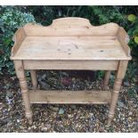 A VICTORIAN PINE WASHSTAND With a shaped galleried top, raised on turned legs and joined by an under