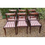 A SET OF SIX REGENCY MAHOGANY BAR BACK CHAIRS With carved rails over striped upholstered drop in