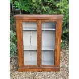 A LATE 19TH CENTURY MAHOGANY AND WALNUT BOOKCASE With glazed panelled doors flanked by incised