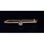 A VINTAGE 14CT GOLD AND DIAMOND BROOCH The single round cut diamond collet set on a plain gold