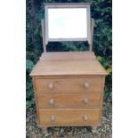 A VICTORIAN PINE DRESSING CHEST With a vanity mirror over three long graduated drawers, raised on