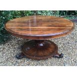 A 19TH CENTURY ROSEWOOD BREAKFAST TABLE With tilt top raised on a lotus flower base, with carved and