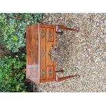 AN 18TH CENTURY OAK LOWBOY Having one long over two short drawers and a shaped kneehole, raised on