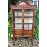 AN EDWARDIAN MAHOGANY AND CROSSBANDED DOME TOP CABINET With astragal glazed and painted panel