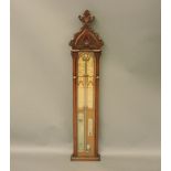 An Admiral Fitzroy barometer, the oak case carved with a Gothic arch and foliage, 127cm tall
