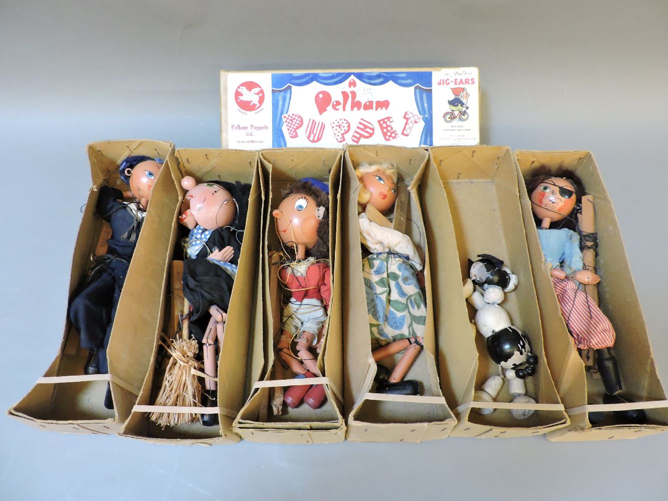Six Pelham Puppets, Witch, Pirate, German Girl, Noddy, Sailor, and Dog, in brown boxes, no lids
