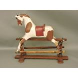 An early 20th century rocking horse, on stained pine stand, 112cm wide, 97cm high