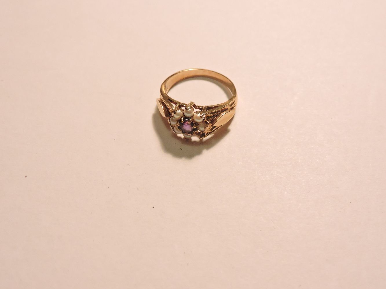 A 9ct gold amethyst and cultured pearl cluster ring, one deficient