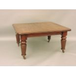 A Victorian mahogany wind out extending dining table, the rectangular top with two additional