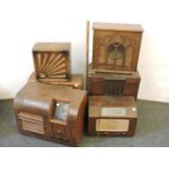 Four old radio sets, including Marconi, Bush, Pye, and two speakers, all in wooden cabinets