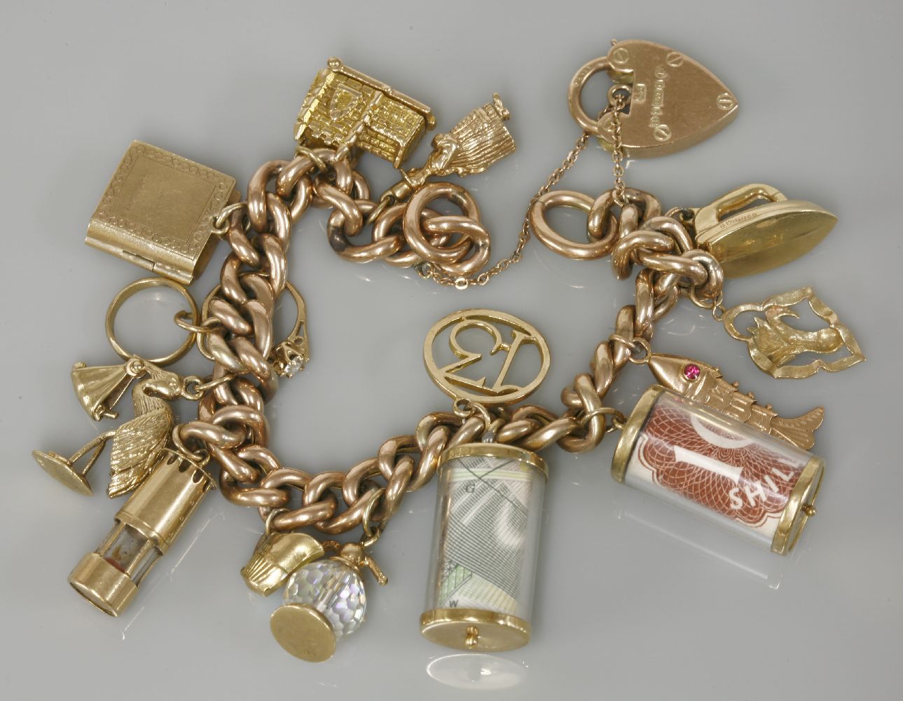 A 9ct gold bracelet, Chester 1903, and fourteen charms attached